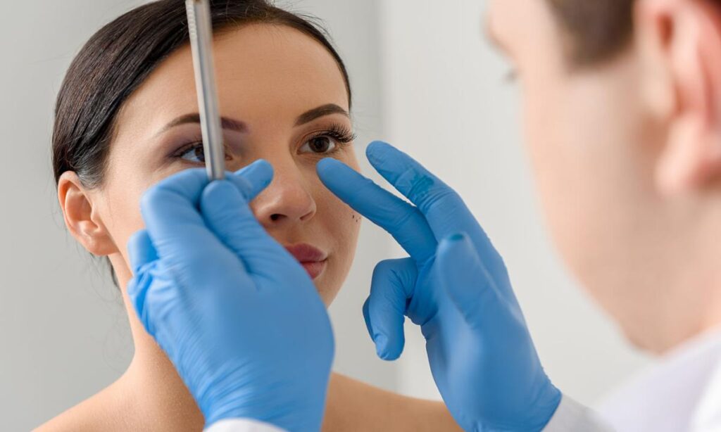 Cirujano preparando a paciente para rinoplastia.