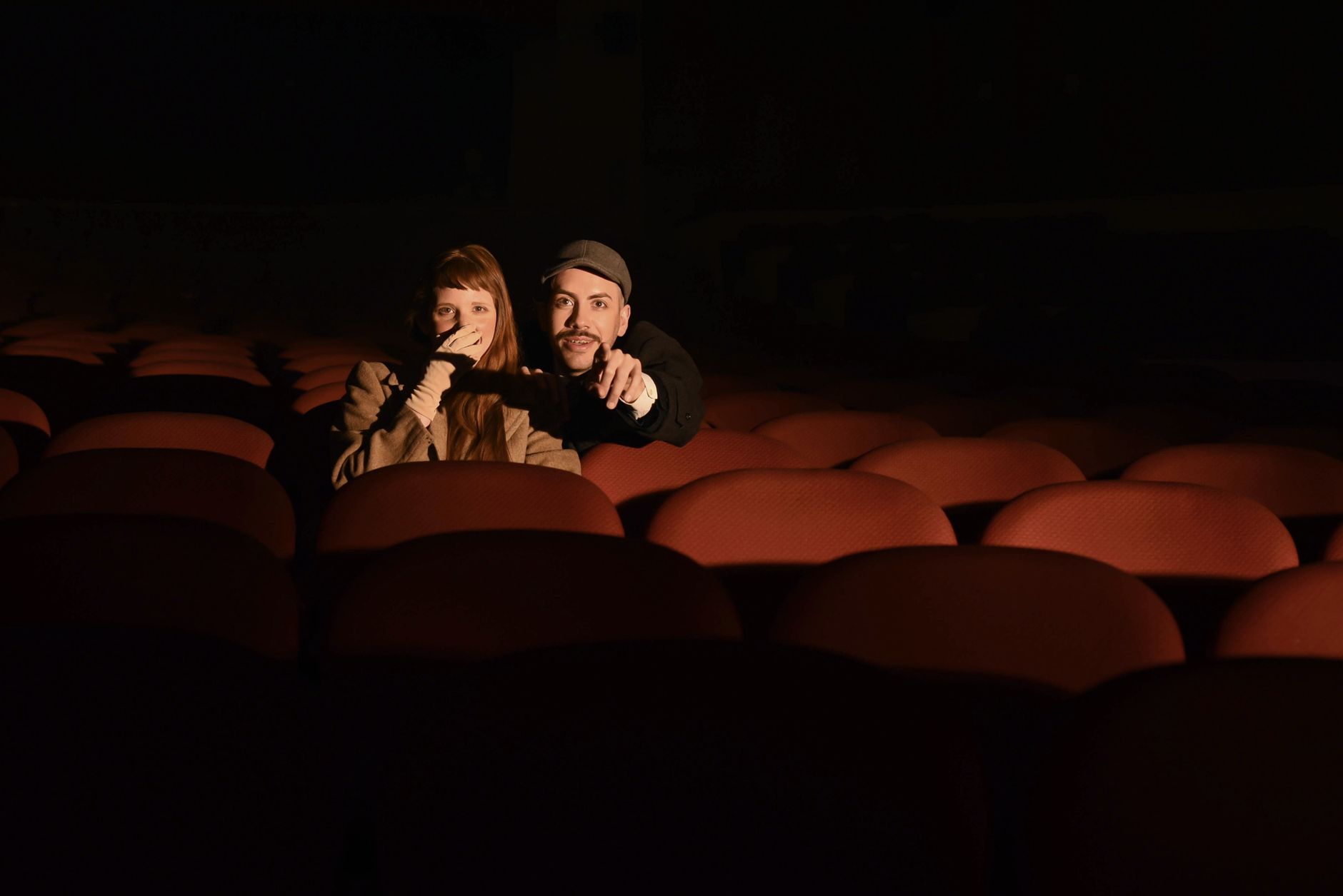 Pareja sentada en una sala de cine con poca luz, imagen ilustrativa para quienes disfrutan las franquicias animadas